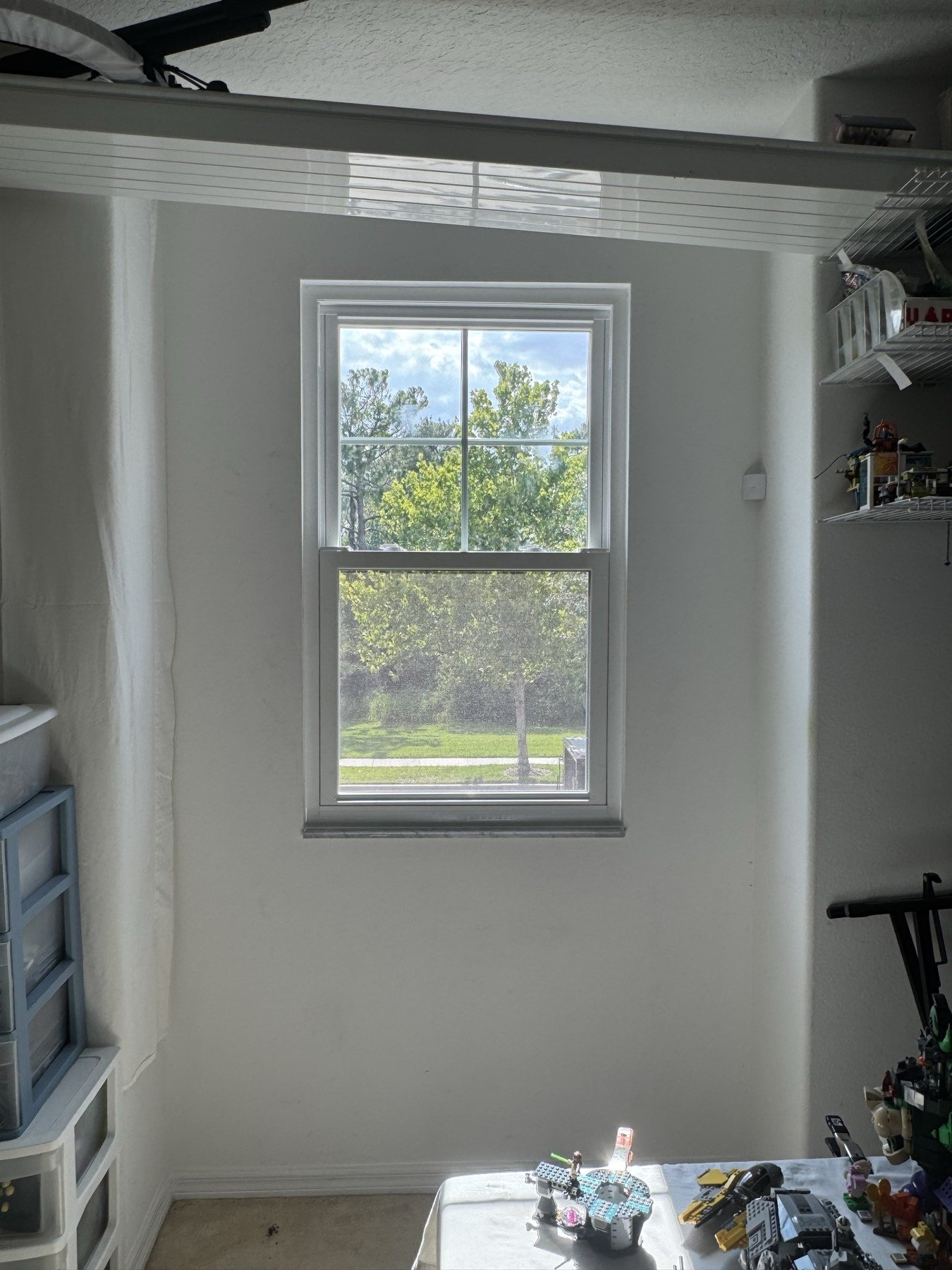 Interior view of new impact window — clean installation in garage