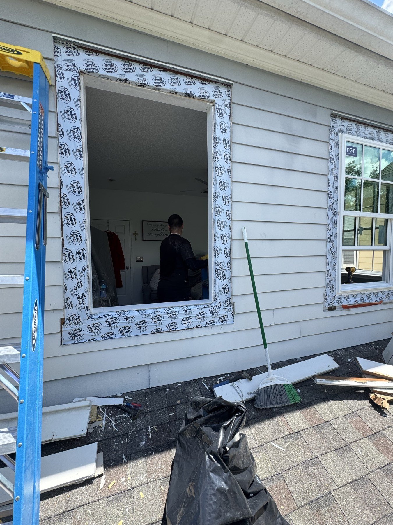 House exterior during window replacement — Protecto Wrap barrier